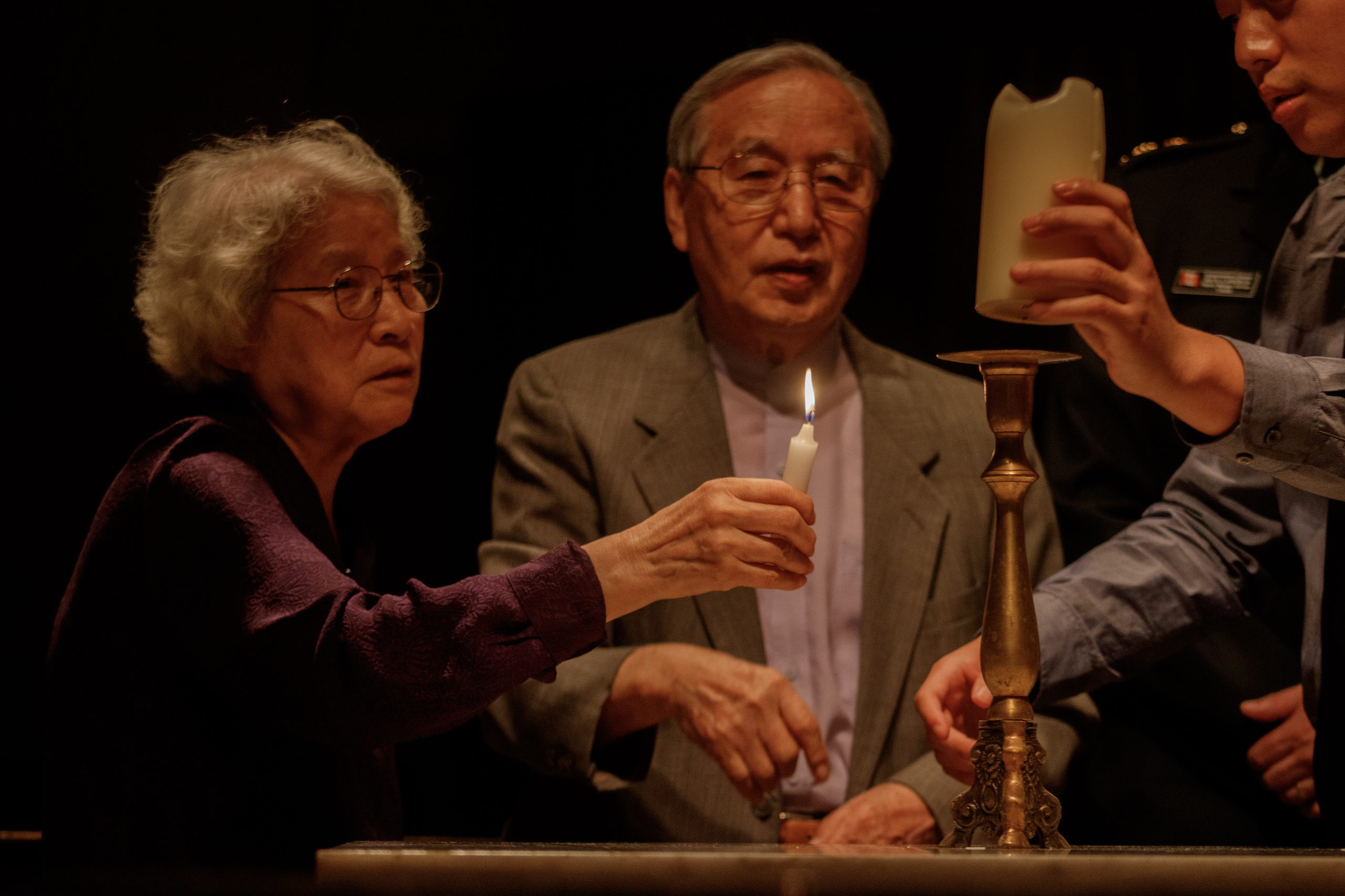 A candle is lit to honor families divided by the Korean War